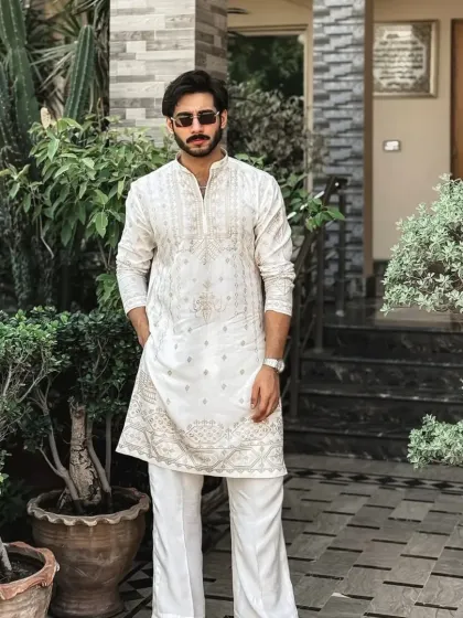 The white and gold kurta styled for an outdoor setting.