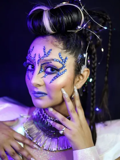 A close-up of the crystal face art. You will learn how to apply gems and other 3D elements securely and artistically.
