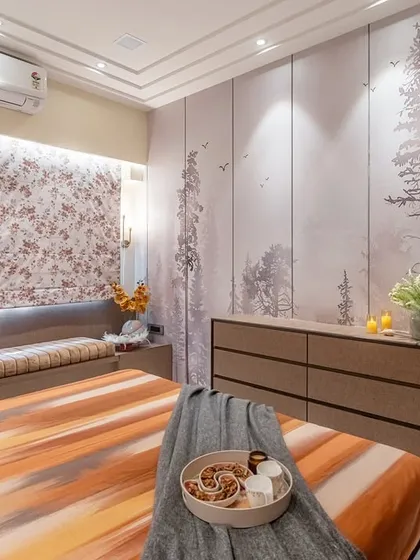 Another view of the bedroom, showing the interplay between the forest wallpaper, the patterned roman blinds, and the warm tones of the bedding. Every element is chosen to contribute to a cohesive and tranquil atmosphere.