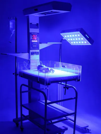 Our studio is equipped for specialized photoshoots, including technical medical equipment. This shot of a neonatal warmer with its phototherapy light activated demonstrates our ability to capture products in their functional state, highlighting key features for professional catalogs and websites.