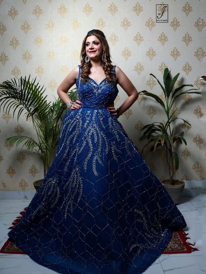 A confident pose with hands on hips, emphasizing the structure and fit of the formal gown.