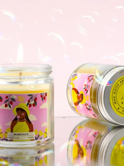 This playful shot captures the fun of a bubblegum-scented candle. The bubbles floating in the background and the reflective surface enhance the whimsical and nostalgic feeling of the product.