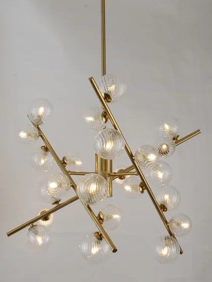 A classic sputnik chandelier with textured glass globes on a brass frame. This design offers a timeless modern look for any room.