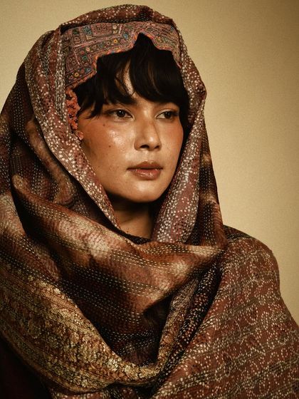 A soulful portrait for House of Wandering Silk, with the model enveloped in a beautifully printed scarf. The warm tones create an intimate mood.