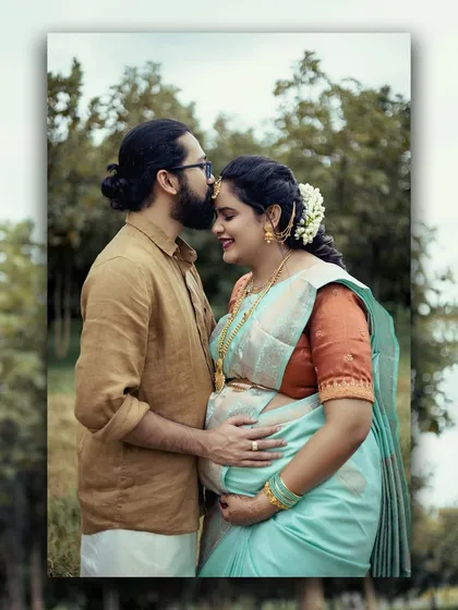 A tender moment between an expecting couple during their traditional Seemantham ceremony. The father-to-be kisses the baby bump, showcasing our expertise in capturing culturally significant family events with grace and emotion.