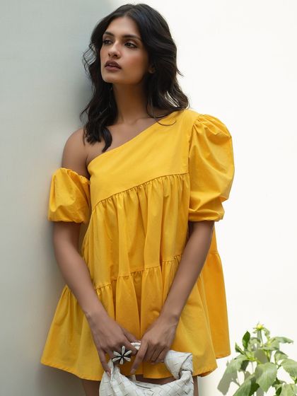 A stylish three-quarter shot for Itgirl Love's summer collection. The model's confident pose and the bright yellow dress make for a perfect social media or campaign image.