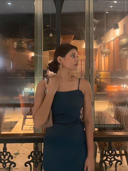 The full look, showing how the simple dress, elegant hairstyle, and minimal accessories come together for a polished evening style.