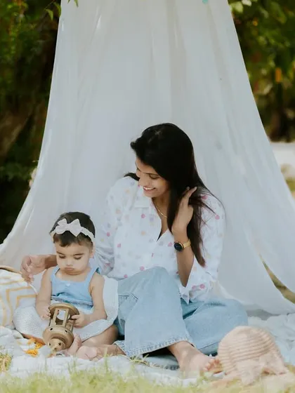 A quiet moment with mom and baby. The outdoor tent setup creates a magical, storybook feel.