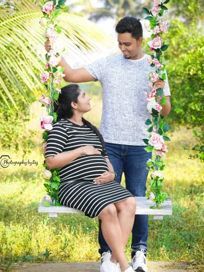 A casual and sweet couples portrait on our floral swing. The black and white striped dress offers a modern, relaxed look for an outdoor maternity session.