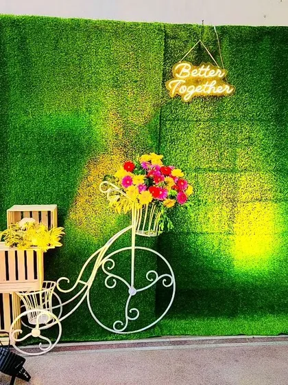 We believe in creating fun experiences for your guests. This charming photo booth, with its green wall, "Better Together" neon sign, and vintage bicycle prop, is a perfect example of how we add memorable touches to your wedding.