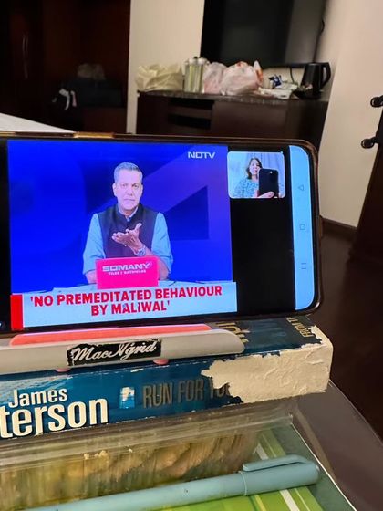Even while traveling in Leh, I had to join an NDTV discussion on the Pune Porsche case. This 'jugaad' setup with my phone propped on books shows my commitment to speaking out against a corrupt system, no matter where I am.