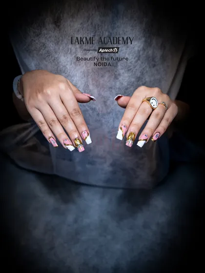 A clear, direct shot of the finished pink and gold chrome nails. This view allows potential students to appreciate the clean application and the beautiful shine achieved with our techniques.
