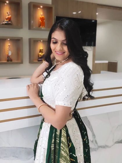 A client dressed for Navratri or a similar festive party. The look is fresh and pretty, with soft curls and minimal makeup.