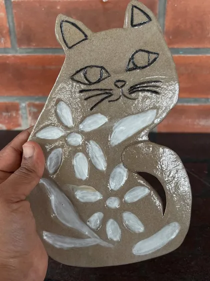 A finished cat-shaped paint palette, hand-built and painted. This piece is ready for its artist to start creating with watercolors.