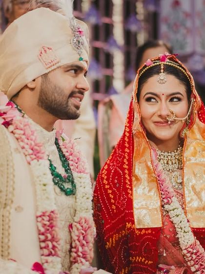 A quiet, stolen glance between the couple during the wedding rituals. Amidst all the grandeur, these are the small, intimate moments that truly define the day.