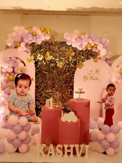 A magical butterfly garden was the theme for Kashvi's first birthday celebration. We used soft pastel pink and lavender balloons, large custom butterfly wing cutouts, and a shimmering gold sequin backdrop to create this enchanting and delicate setting for the little princess.