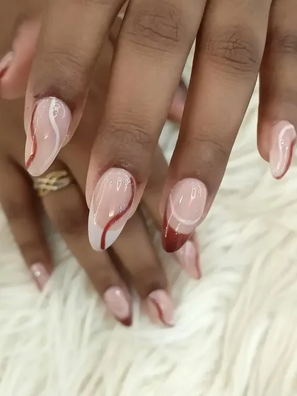 A subtle and chic design with a sheer nude base, accented with abstract swirls in white and deep red.