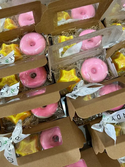 Multiple donut and star soap boxes ready for a party, showcasing consistent quality in bulk orders.