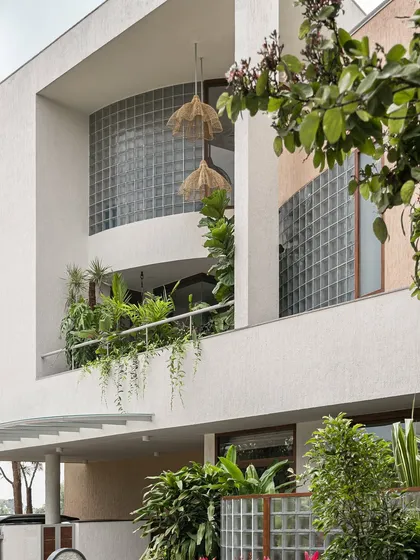 Here, the home's facade becomes a living garden. We integrated deep planters into the balconies, allowing vines and tropical foliage to cascade down, softening the structure and creating a vibrant, green exterior.