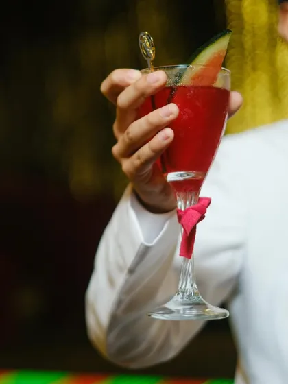 Every drink we craft is a work of art. This vibrant red watermelon cocktail, served in a delicate glass with a matching bow, was part of a scarlet-themed Navjote, perfectly capturing the event's elegant and celebratory mood.