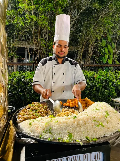 My chef expertly mixes ingredients for the Mutton Tawa Pulao, a live-cooked rice dish that is a feast for both the eyes and the palate.