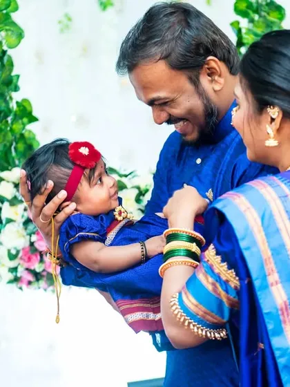 A heartwarming photo of parents looking lovingly at their baby girl during her Naming Ceremony.