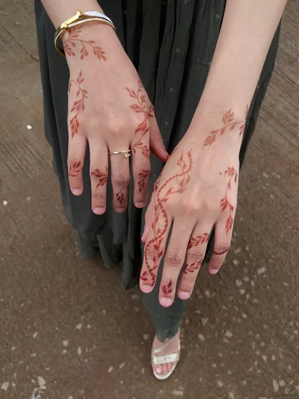 Another view of the simple and elegant vine design, showing how it gracefully adorns both hands.