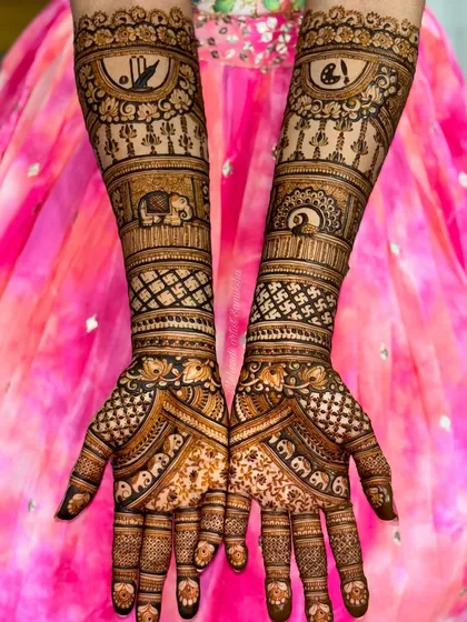 This design is filled with auspicious symbols like elephants and the Om sign. The symmetrical patterns and clean execution make it a perfect choice for a traditional bride.