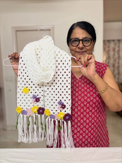 This white crochet scarf features a beautiful combination of yellow, purple, and pink flowers. I love creating new color palettes for my customers.