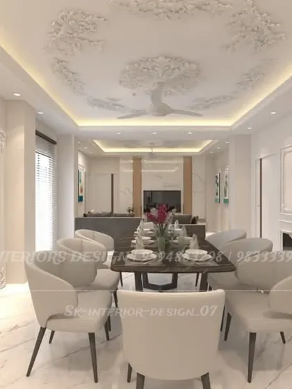 A wider view of the classic dining room, showing its connection to the living area. The intricate ceiling rose and cove lighting add a touch of timeless grandeur.
