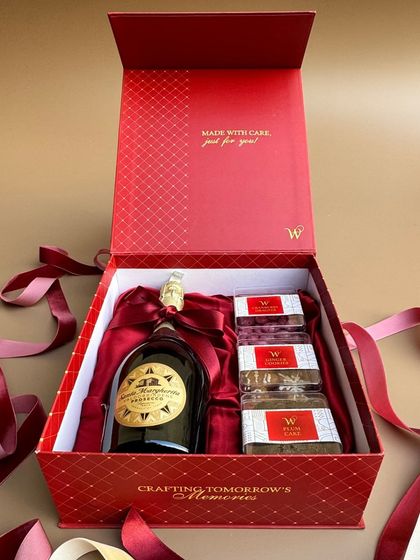 The "Wishit Signature Box 2.0" surrounded by festive ribbons. This luxurious red box is perfect for milestones, thank-you gifts, or any just-because celebration.