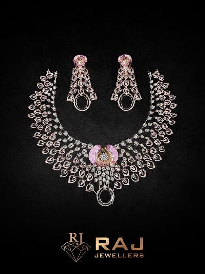 A stunning necklace featuring a fan of leaf-like elements in rose gold, centered with a pink gemstone. The design is both natural and glamorous, making it a unique statement piece.