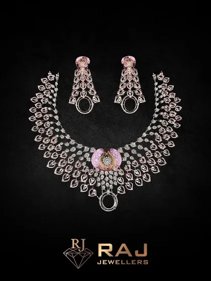 A stunning necklace featuring a fan of leaf-like elements in rose gold, centered with a pink gemstone. The design is both natural and glamorous, making it a unique statement piece.