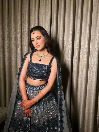 The full look, showing how the shimmery makeup complements the sparkling navy lehenga, creating a look of pure modern elegance.