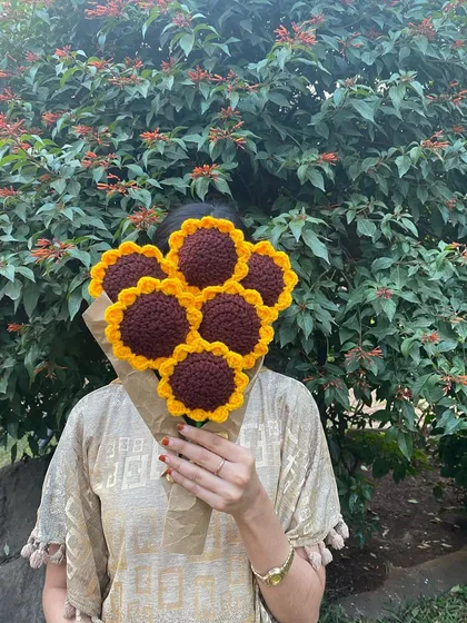 There's something so happy about sunflowers. Here is a full bouquet of them, made by hand and wrapped in simple brown paper to give it a rustic feel. It’s like holding a bundle of sunshine that will never fade.