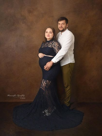 A timeless and elegant couple's portrait. The simple dark lace dress and the partner's embrace create a sophisticated and intimate image.