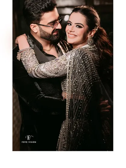 A candid moment of laughter and connection. This photo shows the couple enjoying their party, with a natural and joyful interaction that we love to capture.
