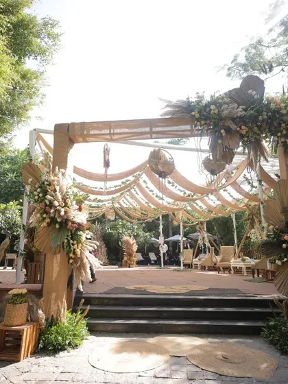 This entrance showcases our skill in creating rustic and boho-themed wedding decor. We used natural textures like jute fabric, dried pampas grass, and large floral arrangements to create a warm, earthy, and inviting entryway for a beautiful garden wedding.