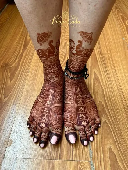 The beautiful henna stain on a bride's feet, showcasing the rich, dark color achieved with my special henna paste. The design features royal elephants under umbrellas.