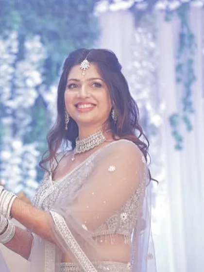 A close-up of the bride's happy smile. Her subtle glam makeup featured a dewy base and soft waves, perfect for her engagement party.