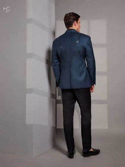 The back of the blue cocktail jacket features continued embroidery detailing, ensuring the design is thoughtful and complete from every perspective.