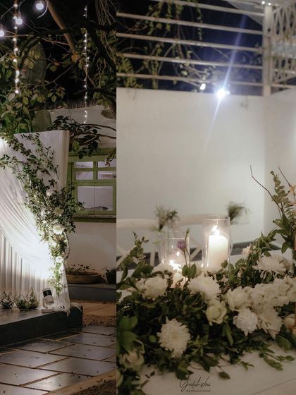 Detail shots of the evening reception decor, including candlelit tables and draped fabric with floral accents, which add to the romantic atmosphere.