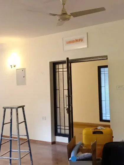 This image shows a finished living area featuring a main door with a black painted finish, demonstrating my work on different door types and materials.
