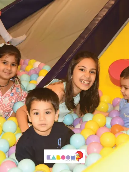 A happy group of friends enjoying the ball pit. It's a wonderful place for kids of all ages to play.
