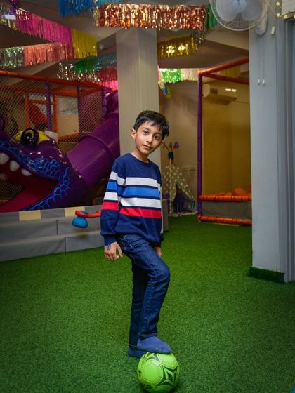 This young soccer star is ready to score a goal on our indoor turf. The mini soccer net is perfect for a friendly match.
