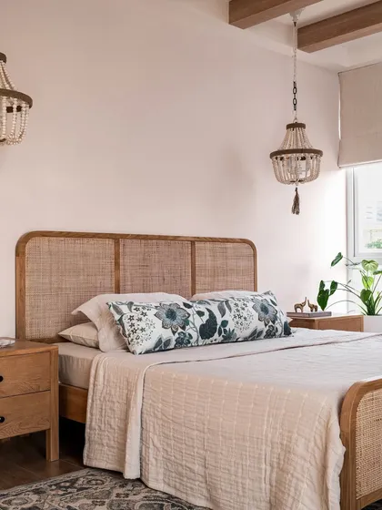 We believe bedrooms should be serene retreats. In the Aqua Home, we used a soft blush palette, a cane bed, and beaded chandeliers to create a calm, laid-back space that still feels elevated and special.