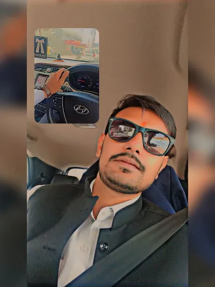 On the road, wearing the formal attire of an advocate. My professional identity is a constant, whether I am in the courtroom, in my office, or traveling for a case.