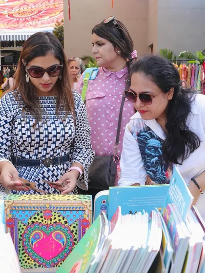 Customers carefully browsing the collection at one of our pop-up stalls. I make sure to have a wide variety of books so there is something for every age and interest.