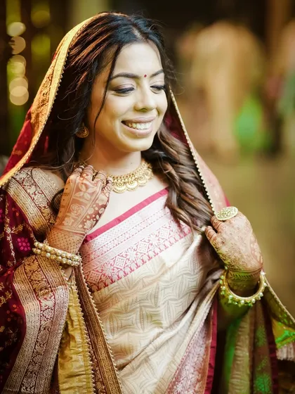 A happy and radiant bridal portrait in a traditional saree.