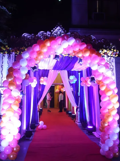 A grand and majestic entrance for a princess-themed party. We combined a large balloon arch with elegant drapery and uplighting to create a royal welcome for the birthday girl and her guests.